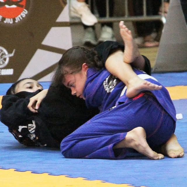 Aluna praticando raspagem no treino feminino